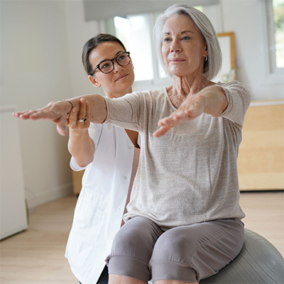 Rehab therapist with a resident in the rehab gym