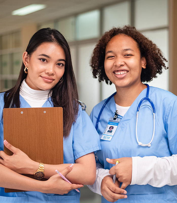 Two nurses smiling together.